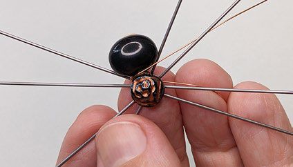 Wire loop around the beaded component between the two beads